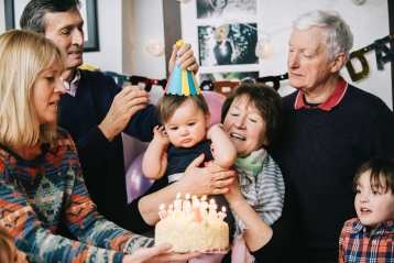 A family celebrating a baby's first birthday